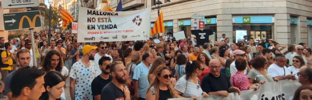 They don't want tourists in the country! 10,000 people took to the streets with giant banners