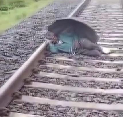 A man sleeping on the tracks in India narrowly escaped death