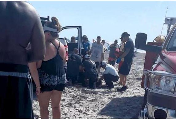 Woman sunbathing trapped under police car in a horrific accident on the beach