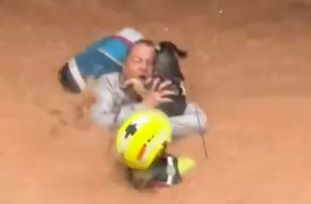 A woman and her dog swept away by floodwaters in Spain were rescued at the last moment