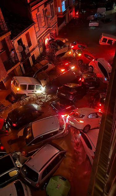 A woman and her dog swept away by floodwaters in Spain were rescued at the last moment