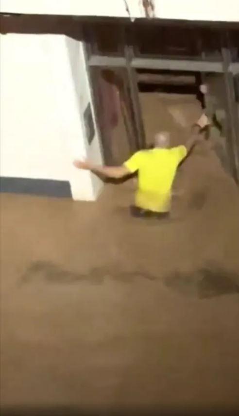 The heroic teacher rescued students trapped in floodwaters by breaking the glass door