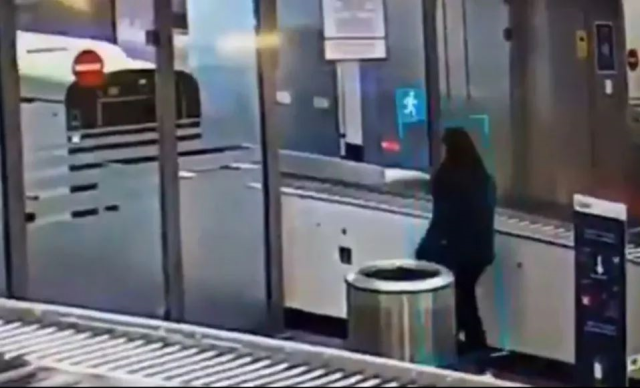 A ticketless female passenger crawled under the security barrier and boarded the plane