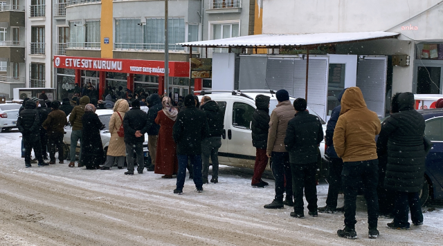 They waited for hours under the snow for cheap meat