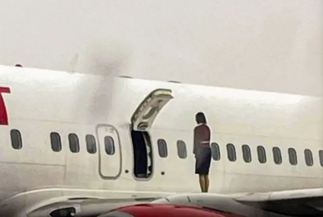 Flight attendants opened the emergency exit door and took a selfie on the wing of the plane