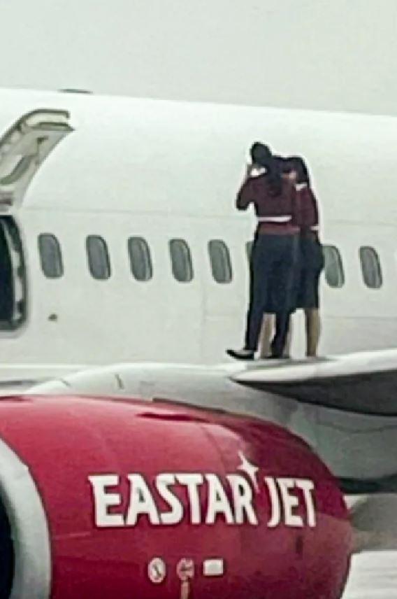 Flight attendants opened the emergency exit door and took a selfie on the wing of the plane