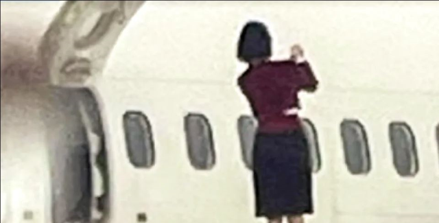 Flight attendants opened the emergency exit door and took a selfie on the wing of the plane