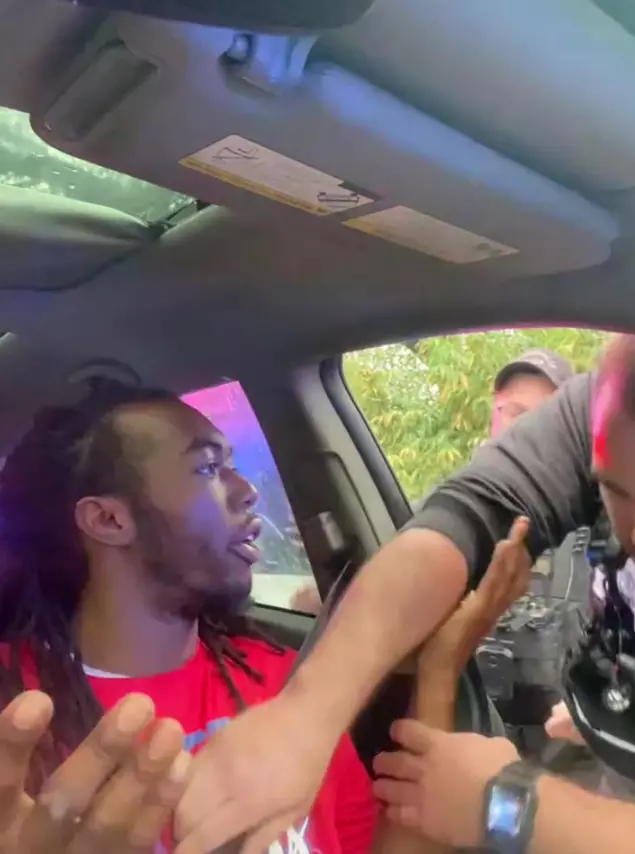 The police broke the car window and punched the driver for not having his headlights on