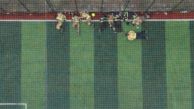 Firefighters who fought the flames for 12 hours rested like this on the field