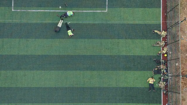 Firefighters who fought the flames for 12 hours rested like this on the field