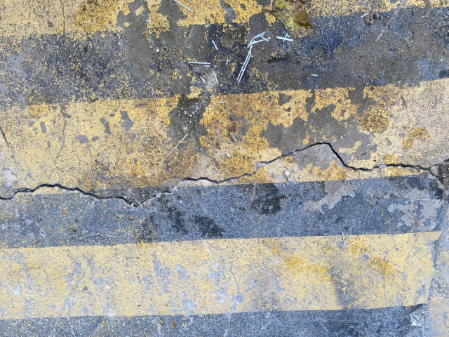 The building's columns exploded, and there are sliding and cracks on the ground