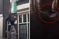 Israeli supporters who took down the Palestinian flag threw it into the river.