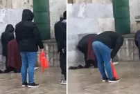 The video of a citizen praying in the rain has divided viewers.