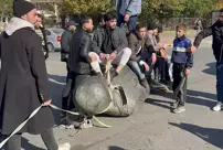 The statue of Hafez al-Assad was dragged in Umayyad Square.