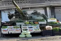 In Syria, an abandoned tank has become a fruit and vegetable stand.