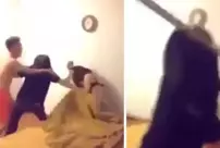 The woman caught in bed with her husband was beaten with a broom and a shoe.