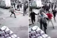 The person performing strange movements in the middle of the street is being beaten up.