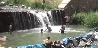 Sıcaktan bunalan çocuklar derede serinliyor