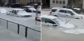 A century-old water pipe burst in Detroit, leaving vehicles stranded in the frozen water.