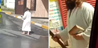 He walked barefoot in the street with a staff in one hand and a book in the other.