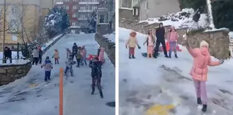 The children sprayed the snow with the snowball maker.