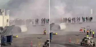 The plane caught fire at the airport! Passengers waited for minutes to be rescued.