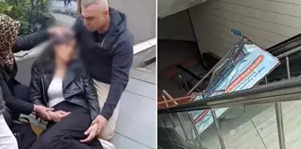 The advertisement board fell on the young woman at the escalators in the metro station.