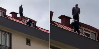 The worker doing the roof renovation took safety precautions by tying a rope around his waist.