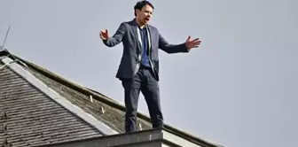 An opposition member of parliament in Slovenia attempted suicide by climbing onto the roof of the parliament building.