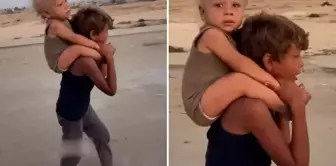 Heartbreaking image from Gaza: Migrating while crying with her brother on her back.
