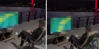 He played video games against the backdrop of the bridge and the strait view.