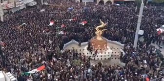 A massive crowd at the funeral of 168 girls who died in the school attack.