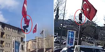 He climbed the 15-meter pole to straighten the flag fluttering in the wind.