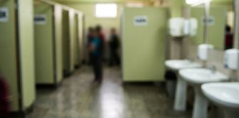 A weapon and a threatening note were found in the school restroom.