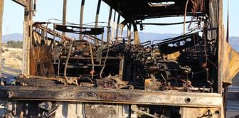 Only a pile of metal remained from the bus where 8 people died.