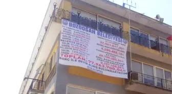 Devraldığı Belediyenin Borçlarını Afişle Duyurdu