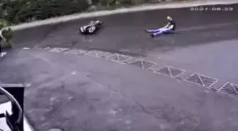 Biker sliding after a fall, saved by a 'hand' of a passerby