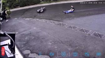 Biker sliding after a fall, saved by a 'hand' of a passerby