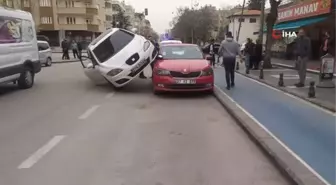 Kaza yapan araç park halindeki aracın üzerinde asılı kaldı