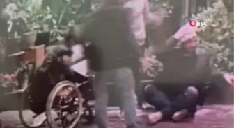 Tekerlekli sandalyeyle gelip yaralı adamın telefonunu çaldı... O anlar kamerada