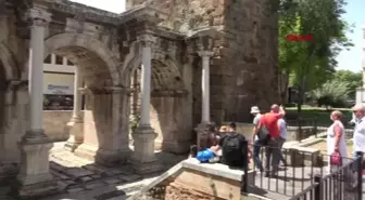 Antalya's historic Hadrianus Gate covered in weeds