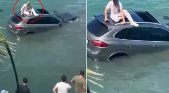 Denize uçan lüks cipin üzerinde dakikalarca kurtarılmayı bekledi