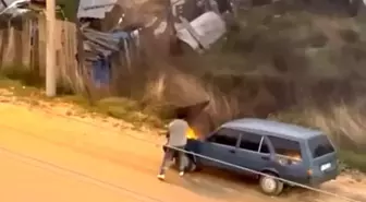 Alev alev yanan aracını kovayla su döküp söndürdü