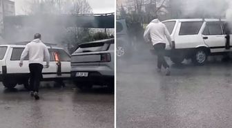 Yanan otomobile yol kenarındaki su birikintisinden doldurduğu kovayla müdahale etti