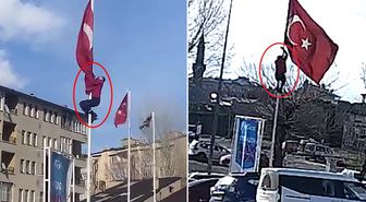 Rüzgarda dolanan bayrağı düzeltmek için 15 metrelik direğe tırmandı