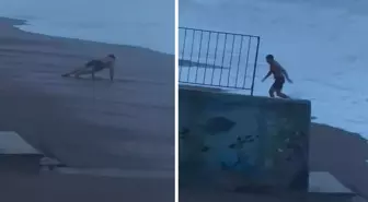Sahilde şınav çekti, 2 metrelik dalgaları görünce koşarak kaçtı