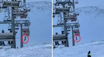 Düşen snowboardını almak için atlamaya çalıştı, telesiyejde asılı kaldı