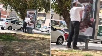Reklam panosundaki afişi sprey boya ile kapattı! Gerekçesi de olay kadar ilginç