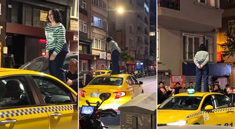 Şişli Kurtuluş’ta taksiciyle tartışan kadın aracın üstüne çıktı: O anlar kamerada