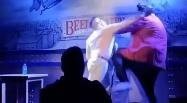 An angry father punched comedian Caravaca, who made sexually explicit comments about his 3-month-old son.